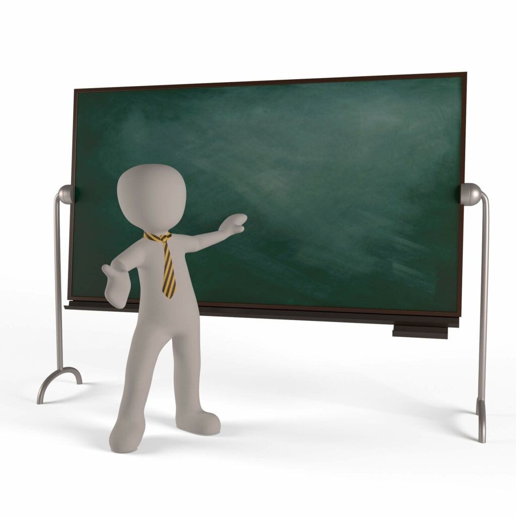 Teacher pointing at a blackboard.
