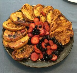 Several pieces of French toast with berries.