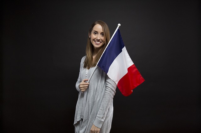 Young woman holding a French flag.