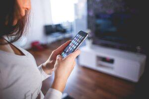 Woman using an iPhone.