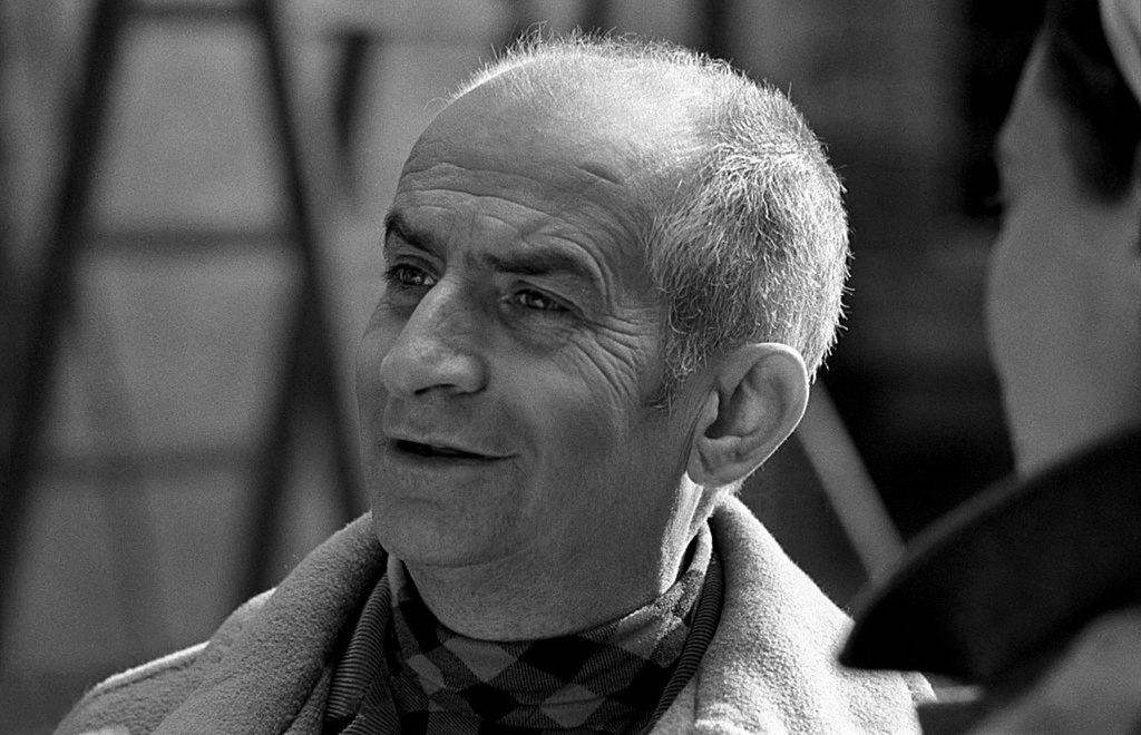 Black and white photo of a bald actor.